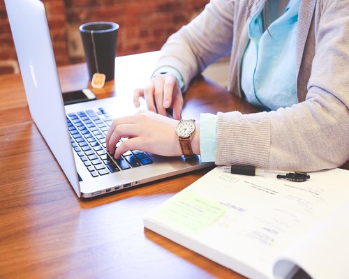 A person typing comfortably on a laptop keyboard